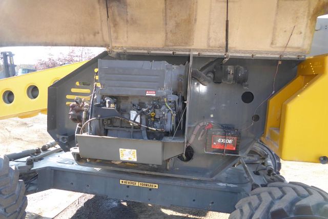 Grove T60 hydraulic crane undercarriage with engine and Exide battery visible.