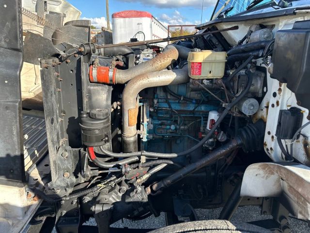 International 4700 engine bay showing radiator, turbo pipes, coolant reservoir, and engine block.