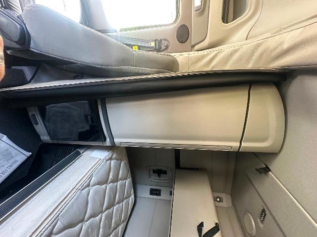 Truck interior dash area of a 2019 Peterbilt 579, beige/gray tones with glove box, passenger seat edge, and cabin compartments visible.