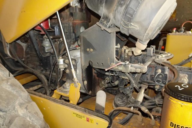 VM106D engine bay showing hydraulic system components and diesel filter canister.