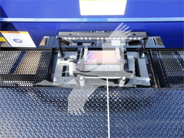 Peterbilt tow truck winch assembly mounted on diamond plate platform in blue equipment body.