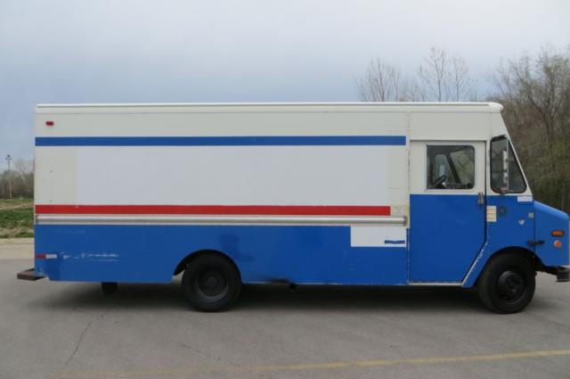 2000 Freightliner MT35 step van in blue and white with red/blue stripes, side view showing cargo box and cab.
