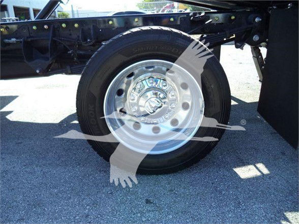 Wheel showing steel rim and tire on Ram 5500 chassis with frame components visible.