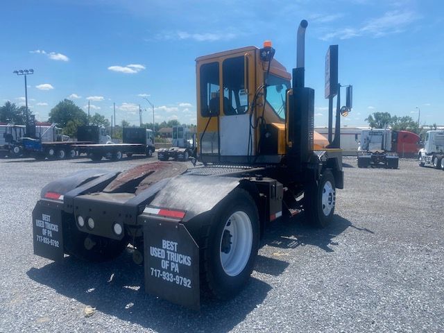 Ottawa T2 yard truck showing cab, black rear fenders with text, and white wheels.