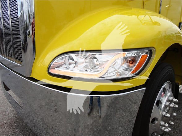 Peterbilt 337 front fender and headlight area in yellow with chrome bumper.