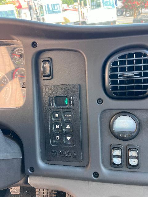 Cab and chassis interior showing shifter panel with R N D, mode switch, and nearby gauges and vents.