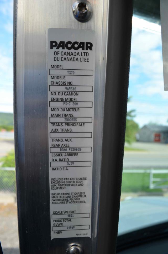 Kenworth T370 truck door pillar badge with model and spec labels including T370, chassis no., engine model PX-7 300, main trans, rear axle details.