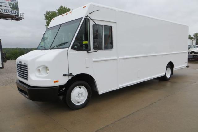Box-style white Freightliner MT45 step van with single cab, large cargo box, front grille, and black bumper. Side shows small door; stock yard in background.