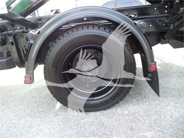 Truck rear wheel and fender of a 2023 Chevrolet SILVERADO 6500HD chassis showing spare tire and fender flares.