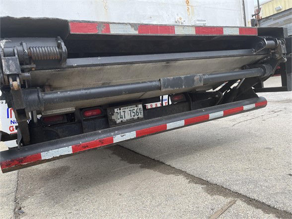Rear view of a 2004 Wabash dry van trailer showing folded or stowed landing gear and compact hydraulic components.