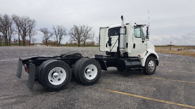 Rear and side view of a white 2007 International 8600 conventional daycab truck chassis with dual rear axles and a cab, parked in an empty lot.