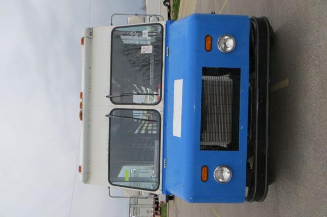Front view of a blue Freightliner MT35 step van with white cab, round headlights, and grill; black bumper; stock number MAG75303 visible.