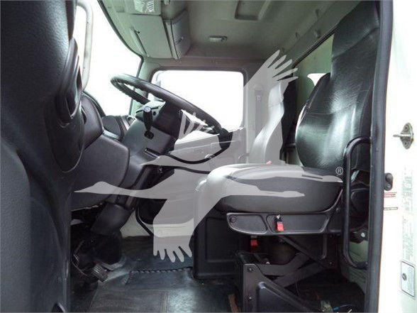 Truck cab interior showing steering wheel, driver seat, and front passenger seat in a reefer truck.
