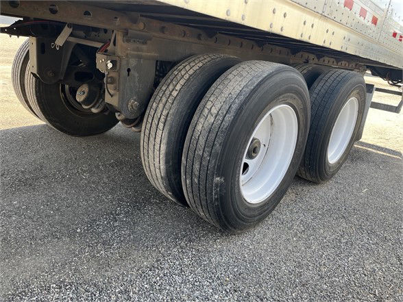 Vanguard dry van trailer rear triple axle wheels with white rims and dual tires, undercarriage visible