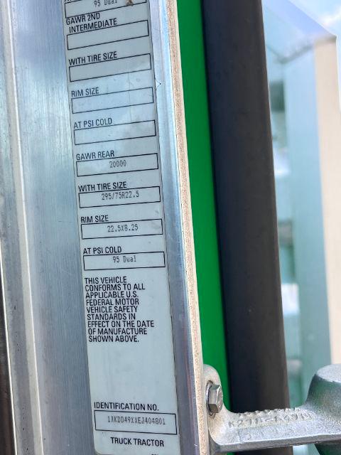 Label panel on Kenworth T800 door shows GAWR rear 20000, with tire size 295/75R22.5 and rim size 22.5x8.25. Vehicle conforms to all applicable Federal Motor Vehicle Safety Standards. Identification No. 1XKD9A9X... Truck tractor.