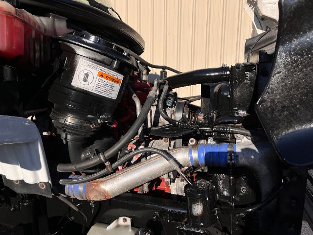 Freightliner M2 cab and chassis engine bay showing turbocharger, hoses, and blue silicon couplings