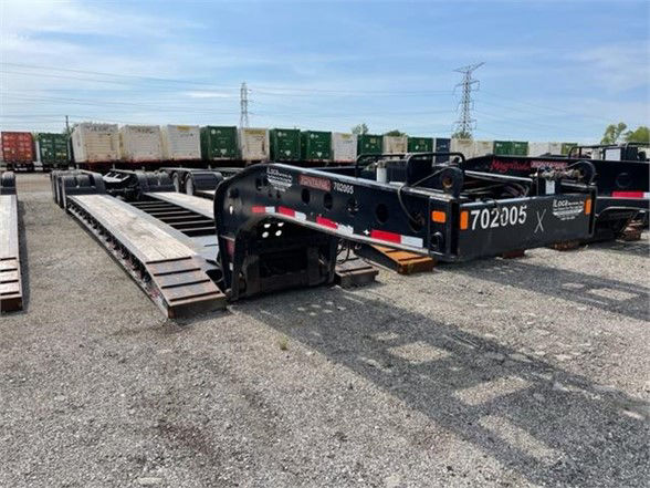  Fontaine 55-ton tri-axle lowboy trailer in yard with ramp sections extended and serial/ID numbers visible on frame.