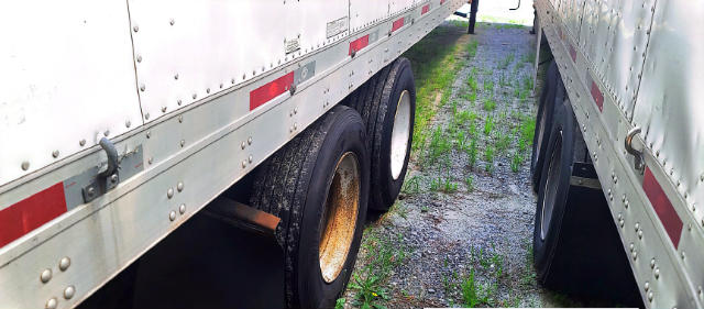 Trailer wheel area showing dual tires and side rails of a Utility 4000 D-X composite trailer.