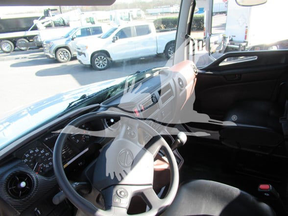 Interior of a 2026 Hino L6 cab showing steering wheel dashboard and front seats.