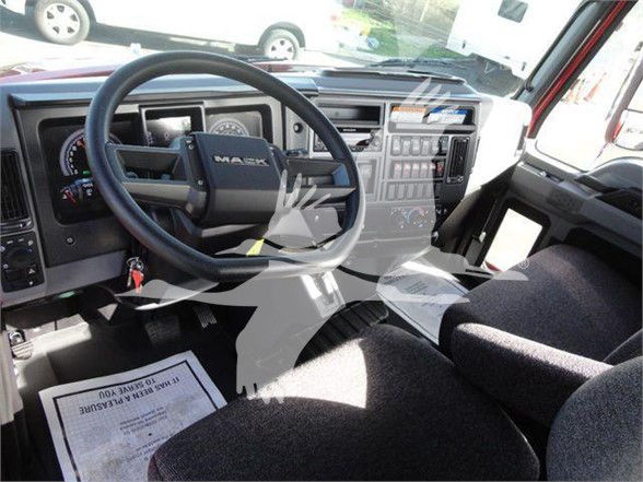 Cab interior of 2024 Mack MD6 showing steering wheel, dashboard with gauges, center console, and driver's seat.