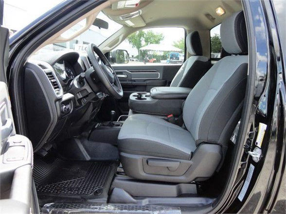 Ram 5500 interior showing front seats, steering wheel, and center console from passenger side.