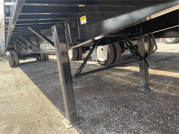 Fontaine VELOCITY steel flatbed trailer undercarriage showing support legs and dual axles with tires visible.