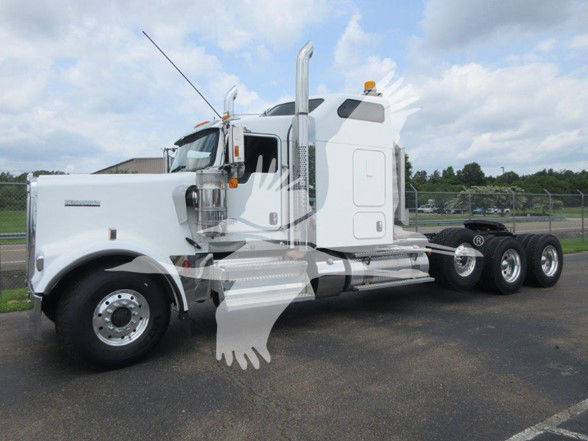 Kenworth W900L conventional sleeper truck in white, side view showing dual rear axles, chrome exhaust stacks, and large fuel tanks.