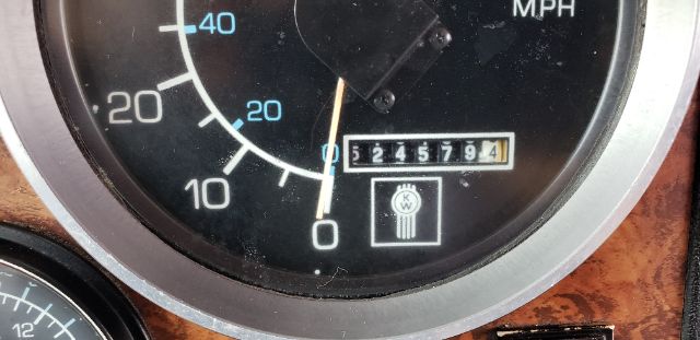 Truck instrument cluster showing speedometer with MPH and odometer digits 524579, woodgrain dash trim.