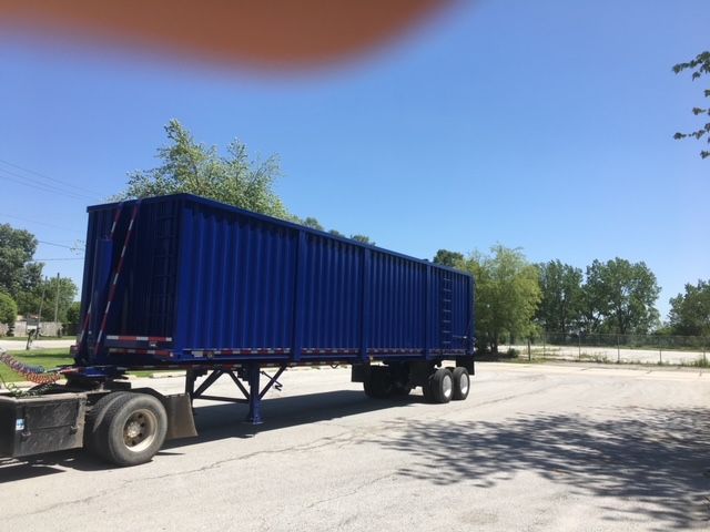 Blue 2006 Utility 40 ft square dump trailer attached to a semi-truck on a paved lot.