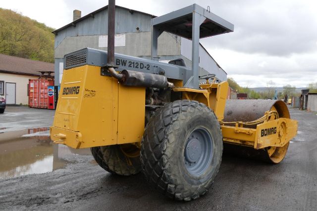 Bomag BW212D-2 vibratory roller in yellow with large rear drum and front engine compartment, side label BW 212 D-2.
