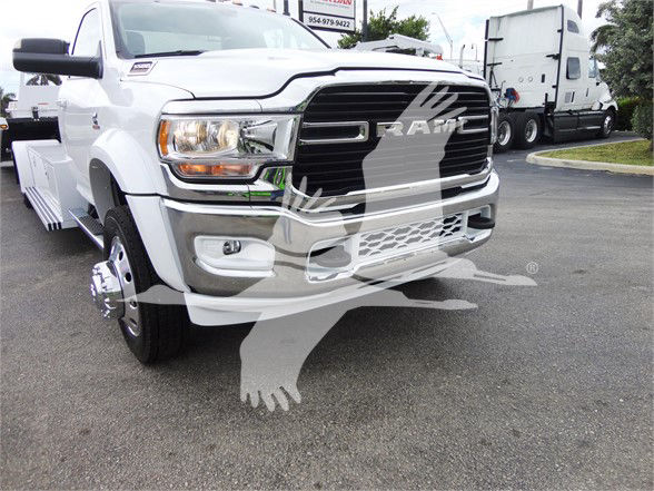 Ram 5500 HD tow truck front view showing chrome grille, headlamps, and bumper with large Ram badge overlay.