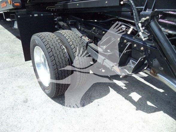 Two rear wheels of a Ram 5500 chassis with dual tires and suspension components visible under a heavy-duty truck frame.