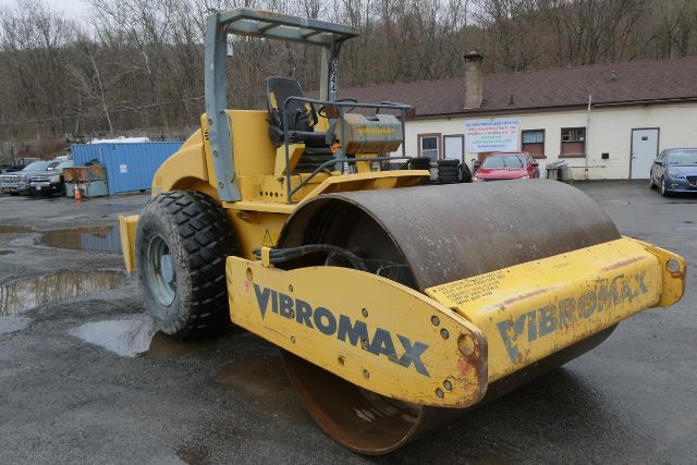 Vibromax VM106D tandem roller showing front drum and operator seat with yellow paint and black Vibromax branding.
