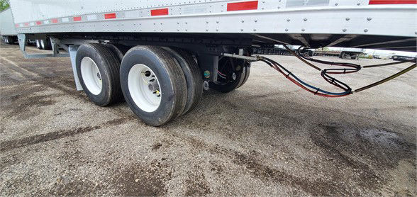 Vanguard MAXCUBE dry van trailer undercarriage showing dual rear axles and wiring harnesses.