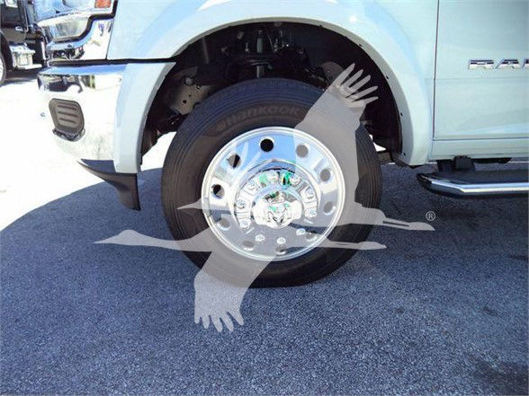 Ram 5500 front wheel and chrome hubcap showing tire and wheel well with blue body panel and fender flare.