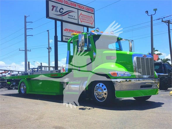 Peterbilt tow truck front and side view showing bright green cab and lowbed, stock J52310.