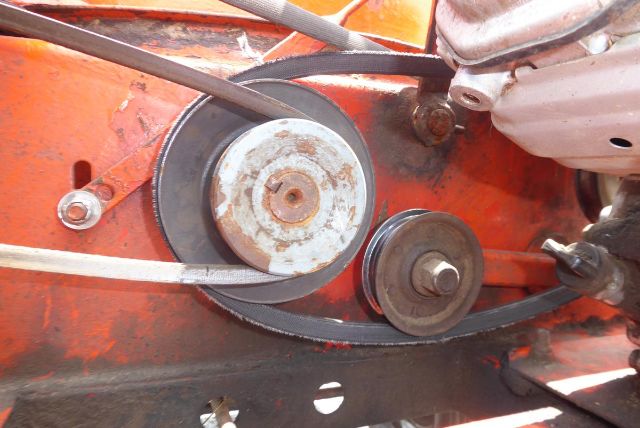 Agri-Metal CA8064 machinery belt system showing pulleys and belt drive in an orange chassis.