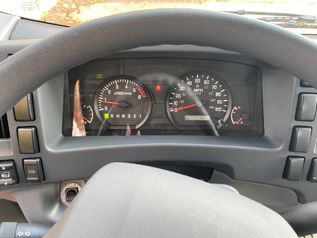 Dashboard of a 2022 Isuzu NRR Gas Cab Chassis showing instrument cluster with tachometer, speedometer, and warning icons.