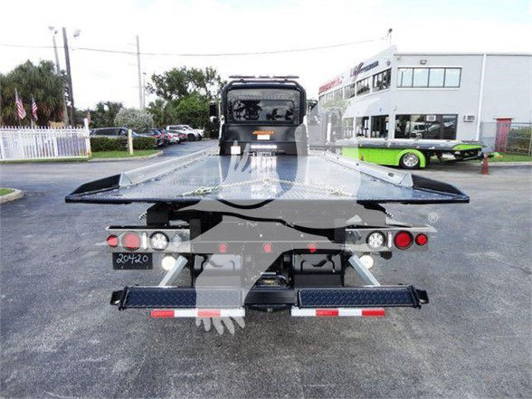 Peterbilt 337 tow truck rear view showing flatbed and taillights.