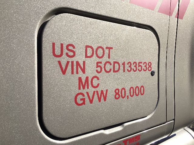 US DOT VIN 5CD133538 MC GVV 80,000 on a recessed door panel of a Peterbilt truck