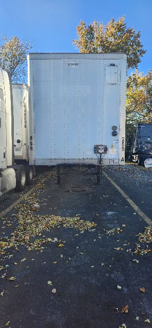 Rear of a light gray 2014 dry van trailer with doors closed, showing riveted metal panels and hinges.