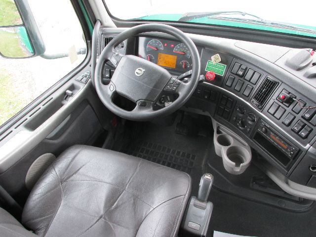 Cab interior of Volvo 780 truck showing steering wheel, dashboard with gauges, and center console.