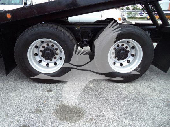 Peterbilt 348 truck undercarriage showing dual rear axles with white steel wheels and black frame.