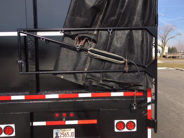 Back of a 2002 Great Dane single drop trailer showing rear frame, tarp mechanism, and taillights.
