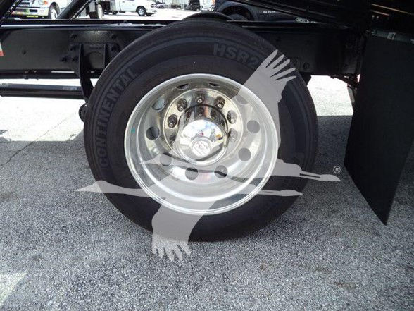 Truck wheel and tire showing Continental HSR tire and polished steel rim.