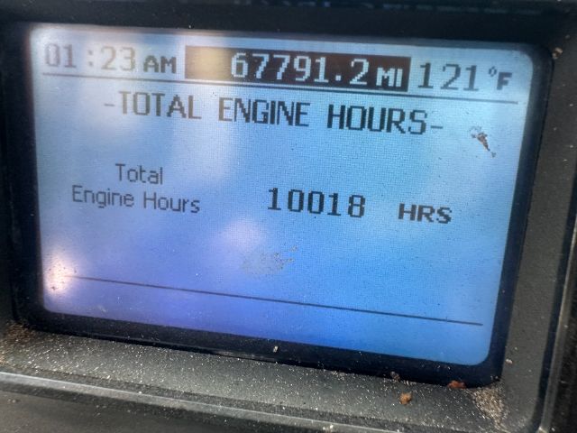 Total engine hours display showing 10018 HRS, total miles 67791.2 MI, time 01:23 AM, outside temp 121°F.