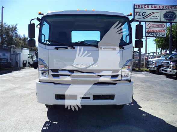 Isuzu FTR truck front view showing cab, grille, headlights, and bumper in a dealership lot.
