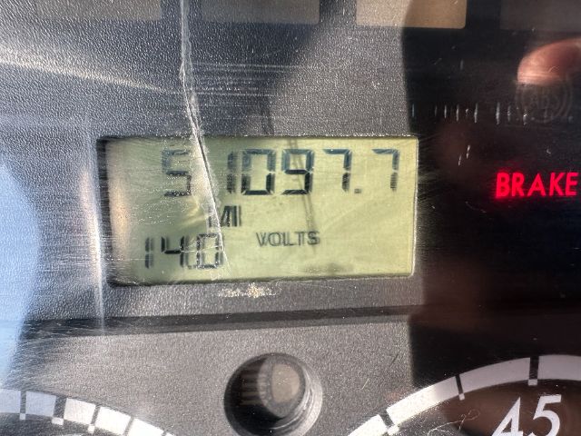 Dashboard display shows 51097.7 miles and 140 volts. Brake indicator illuminated.