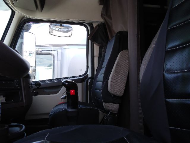 Volvo 670 cabin interior showing driver seat and sleeper area with window and control stalks.
