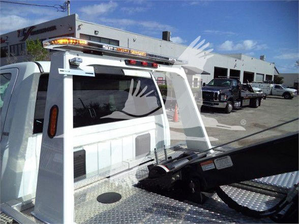 Ram 4500 truck bed with rear utility rack and warning lights visible.